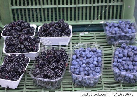 Close up blackberries and blueberries in punnets at Prague market for food background and healthy banner Close up blackberries and blueberries in punnets at Prague market for food background and healthy banner 141639673