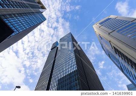 A massive, modern building in the business district, symbolizing the growth of the company. A massive, modern building in the business district, symbolizing the growth of the company. 141639901