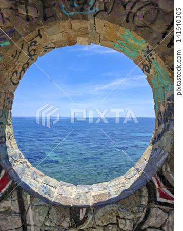 Calpe, Spain - May 27, 2026.Scenic view of the Mediterranean Sea from stone window at Club La Manzanera in Calpe, Spain Calpe, Spain - May 27, 2026.Scenic view of the Mediterranean Sea from stone window at Club La Manzanera in Calpe, Spain 141640305