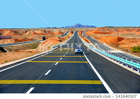 The old and new Silk Roads run parallel to each other across the Gobi Desert in Xinjiang Uyghur, China. The old and new Silk Roads run parallel to each other across the Gobi Desert in Xinjiang Uyghur, China. 141640307