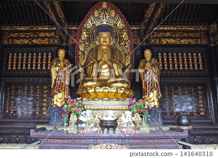 China, Xi'an City, World Heritage Site, Great Ci'en Temple, Giant Wild Goose Pagoda, Shakyamuni Buddha statue and attendant figures in the Great Buddha Hall. China, Xi'an City, World Heritage Site, Great Ci'en Temple, Giant Wild Goose Pagoda, Shakyamuni Buddha statue and attendant figures in the Great Buddha Hall. 141640310