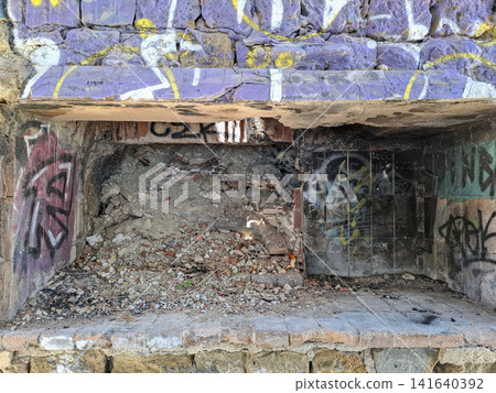 Calpe, Spain - May 27, 2026.Demolished fireplace filled with rubble and colorful graffiti in Club Social La Manzanera in Calpe, Spain Calpe, Spain - May 27, 2026.Demolished fireplace filled with rubble and colorful graffiti in Club Social La Manzanera in Calpe, Spain 141640392