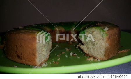 Close up shot of the texture of homemade sponge cake filling on a green tray. Close up shot of the texture of homemade sponge cake filling on a green tray. 141640601