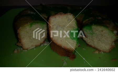 Close up shot of the texture of homemade sponge cake filling on a green tray. Close up shot of the texture of homemade sponge cake filling on a green tray. 141640602