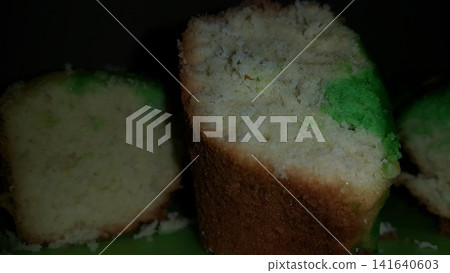 Close up shot of the texture of homemade sponge cake filling on a green tray. 141640603