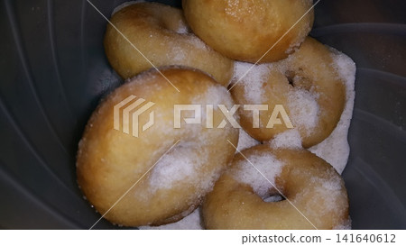 Close up shot of a pile of delicious and indulgent sweet sugar donuts. Close up shot of a pile of delicious and indulgent sweet sugar donuts. 141640612