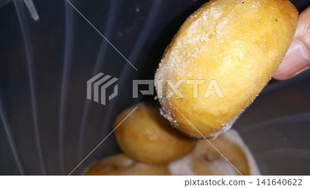 Selective focus shot of delicious and indulgent sweet sugar donut. Donut, Donut or Doughnut, popular cake made from flour and potatoes with icing sugar on top. Selective focus shot of delicious and indulgent sweet sugar donut. Donut, Donut or Doughnut, popular cake made from flour and potatoes with icing sugar on top. 141640622