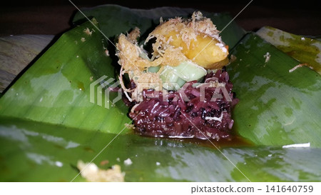 Low angle shot of traditional snacks in Indonesia. a popular snack with brown sugar sauce and grated coconut. Low angle shot of traditional snacks in Indonesia. a popular snack with brown sugar sauce and grated coconut. 141640759