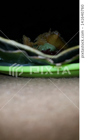 Low angle shot of traditional snacks in Indonesia. a popular snack with brown sugar sauce and grated coconut. Low angle shot of traditional snacks in Indonesia. a popular snack with brown sugar sauce and grated coconut. 141640760