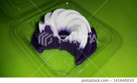 White and purple cake with a smooth texture, already partially eaten. White and purple cake with a smooth texture, already partially eaten. 141640810
