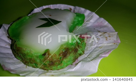 Green and white Lapindo Mud Cake (talam) sprinkled with green pandan leaves looks beautiful and charming. Green and White Lapindo Mud Cake (talam) has been partially eaten. Green and white Lapindo Mud Cake (talam) sprinkled with green pandan leaves looks beautiful and charming. Green and White Lapindo Mud Cake (talam) has been partially eaten. 141640845