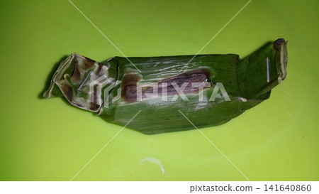 Shot of chicken lemper still wrapped in pisan leaves. Shot of chicken lemper still wrapped in pisan leaves. 141640860