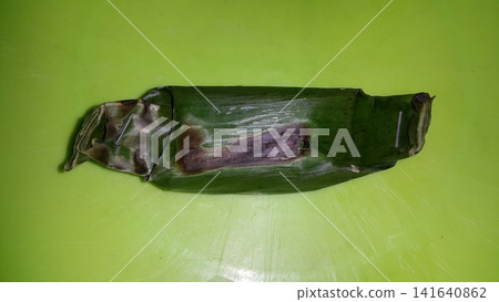 Shot of chicken lemper still wrapped in pisan leaves. Shot of chicken lemper still wrapped in pisan leaves. 141640862