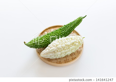White bitter melon and green bitter melon, against a white background. White bitter melon and green bitter melon, against a white background. 141641247