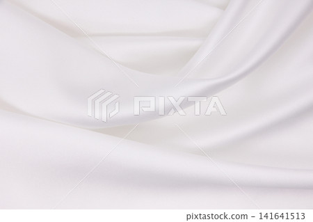 Smooth elegant white silk or satin luxury cloth texture as wedding background. Luxurious background design Smooth elegant white silk or satin luxury cloth texture as wedding background. Luxurious background design 141641513