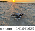 Drone on Sandy Beach Before Sunset Flight 141641625