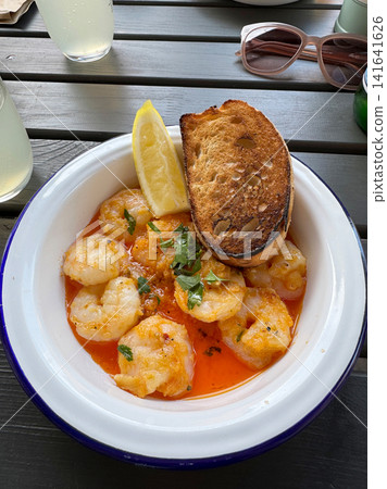 Garlic Shrimp with Toasted Bread and Lemon on Summer Restaurant Terrace, Top View Garlic Shrimp with Toasted Bread and Lemon on Summer Restaurant Terrace, Top View 141641626