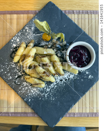 Sweet Dumplings with Chocolate and Berry Sauce 141641955