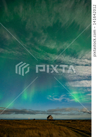 A curtain of green aurora borealis stretches across the entire night sky (Iceland) A curtain of green aurora borealis stretches across the entire night sky (Iceland) 141642012