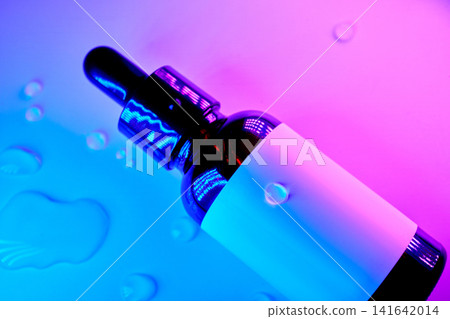 Skincare cosmetic serum in dropper bottle with neon light Skincare cosmetic serum in dropper bottle with neon light 141642014