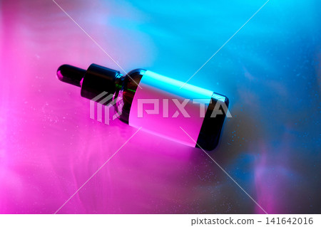 Cosmetic serum dropper bottle glowing with neon light Cosmetic serum dropper bottle glowing with neon light 141642016