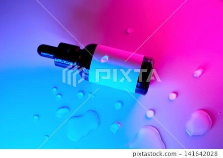 Serum dropper bottle with liquid droplets and neon lighting Serum dropper bottle with liquid droplets and neon lighting 141642028