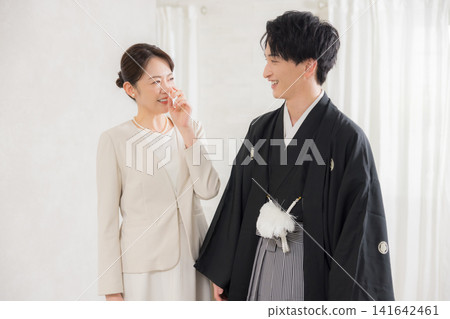 A young man in formal kimono and hakama and his mother. A young man in formal kimono and hakama and his mother. 141642461