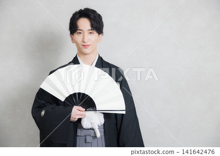 A young man in a hakama with family crest 141642476