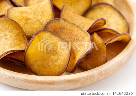 Close-up of sweet potato chips on a plate Close-up of sweet potato chips on a plate 141643280