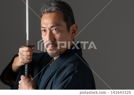 A man with a Japanese sword A man with a Japanese sword 141643320