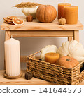 Candles and pumpkins in box on wooden shelves on white backgroun 141644573