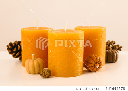 Orange candles and cones on white background Orange candles and cones on white background 141644578