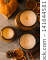 Candles, pumpkins and oranges on gray background, space for text 141644581