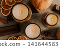 Candles, cinnamon, pumpkins and orange on gray background, top v 141644583