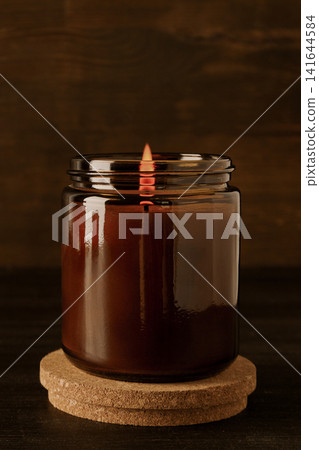 Candle in glass jar on wooden background, space for text Candle in glass jar on wooden background, space for text 141644584