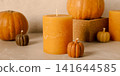 Decorative candles and pumpkins on beige background 141644585