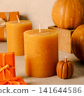 Candles, pumpkins and gift boxes on beige background 141644586