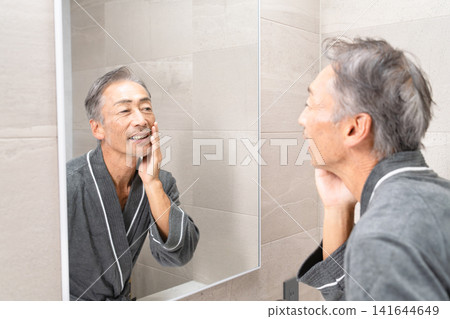 Senior man doing skin care Beauty image Senior man doing skin care Beauty image 141644649