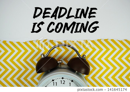 Deadline Is Coming text written on paper with alarm clock on yellow chevron background 141645174