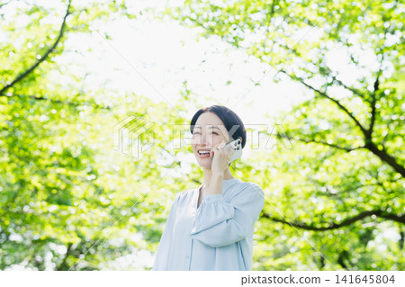 Young woman talking on smartphone Lifestyle image Young woman talking on smartphone Lifestyle image 141645804
