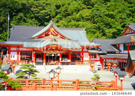 Taikodani Inari Shrine: A magnificent vermilion-lacquered shrine building against a blue sky. One of Japan's five major Inari shrines and a popular tourist spot in Tsuwano. Taikodani Inari Shrine: A magnificent vermilion-lacquered shrine building against a blue sky. One of Japan's five major Inari shrines and a popular tourist spot in Tsuwano. 141646640