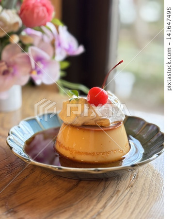 Custard pudding topped with plenty of cream Custard pudding topped with plenty of cream 141647498