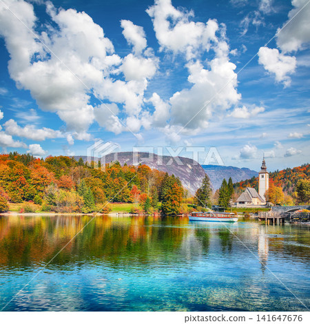 Remarkable view of Church of St. John the Baptist on Bohinj Lake . Remarkable view of Church of St. John the Baptist on Bohinj Lake . 141647676