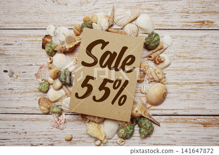 Summer Sale 55% off text on wooden sign decorated with marine nautical on a wooden background Summer Sale 55% off text on wooden sign decorated with marine nautical on a wooden background 141647872