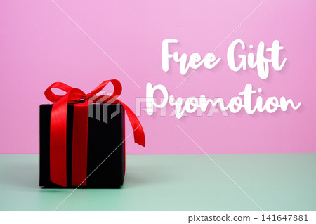 Free Gift Promotion text with gift box on pink background Free Gift Promotion text with gift box on pink background 141647881