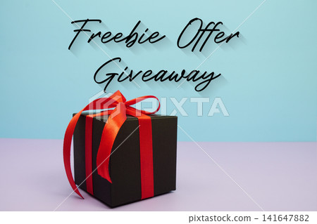 Freebie Offer Giveaway text with gift box on blue background 141647882