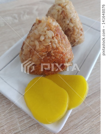 香噴噴的烤飯糰配醬油和醃黃蘿蔔 香噴噴的烤飯糰配醬油和醃黃蘿蔔 141648076
