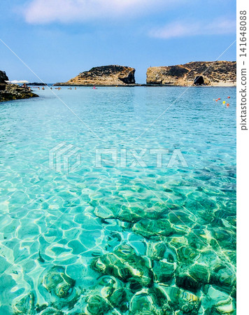 The crystal-clear blue waters of the Blue Lagoon on Comino Island, Malta The crystal-clear blue waters of the Blue Lagoon on Comino Island, Malta 141648088