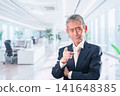 A middle-aged businessman with his head in his hands in the office 141648385