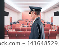 A middle-aged man working as a prison guard at a courthouse. 141648529